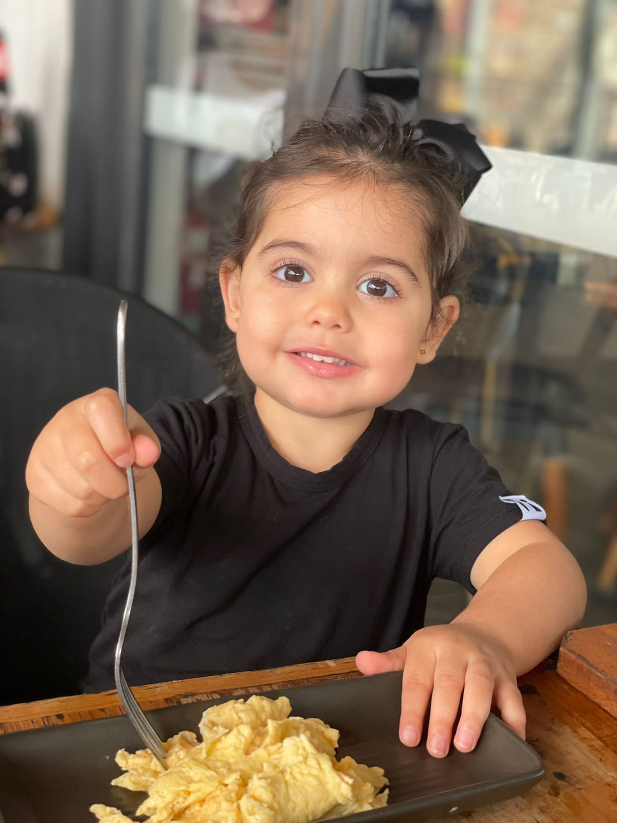 Child eating brunch in a bamboo Baby Todd & Co. tee