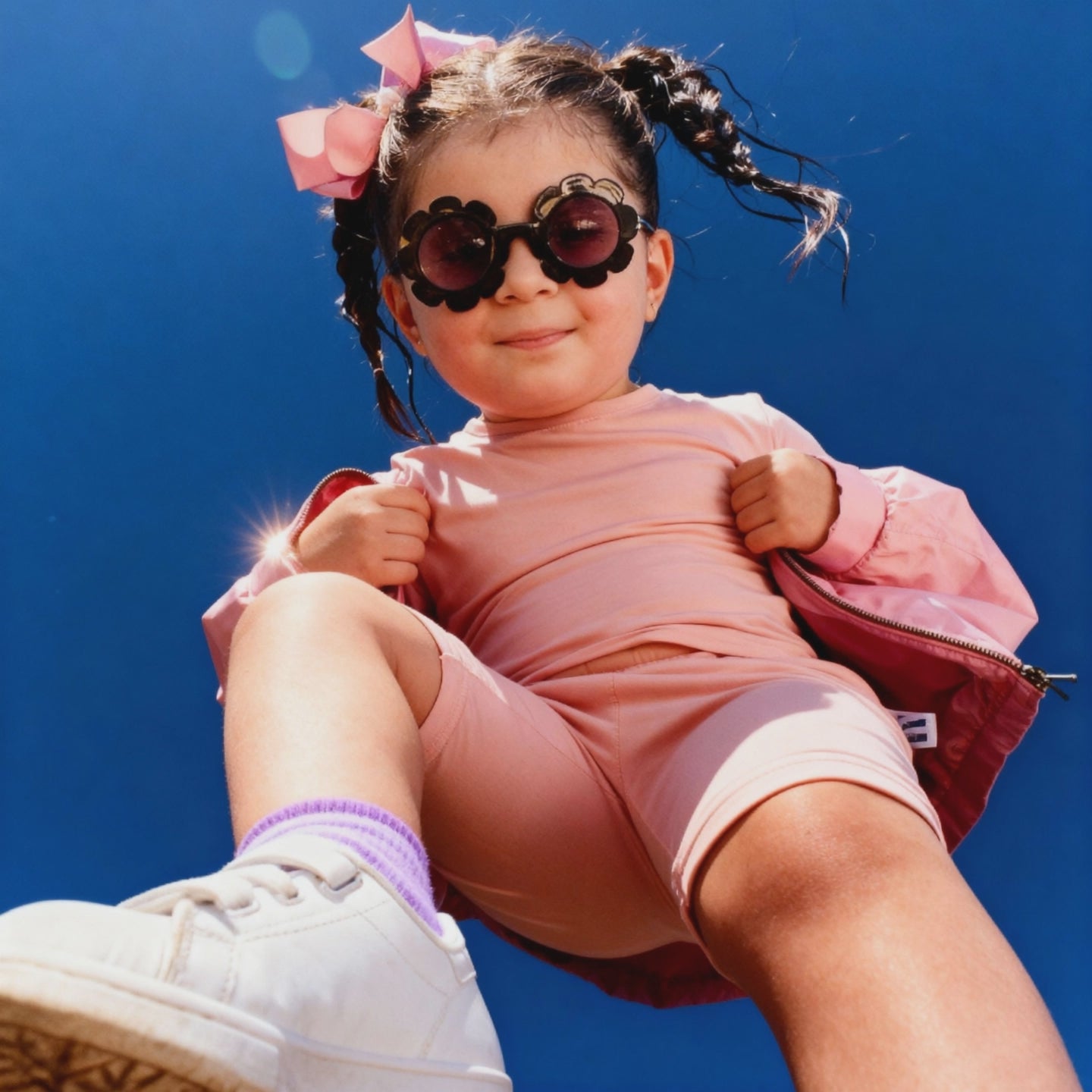 Girl in pink enjoying a summer day wearing sunglasses